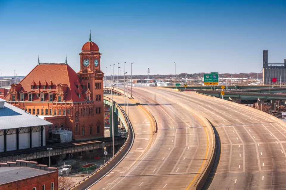 View of empty multi-lane freeway next to historic brick buildingin Richmond, Virginia